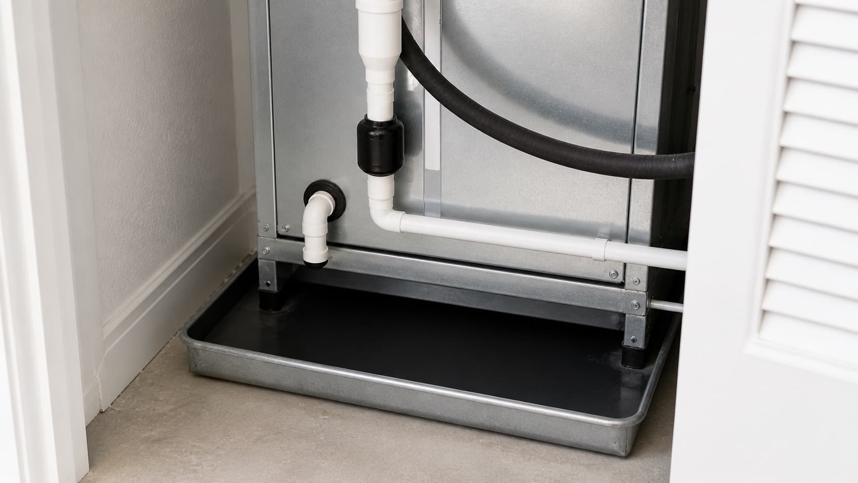 Indoor HVAC air handler area with condensate drain line and pan